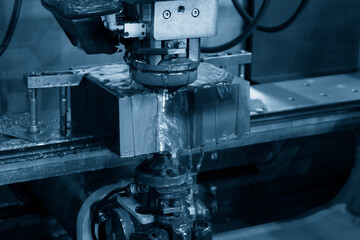 The wire EDM machine cutting the insert mold parts.