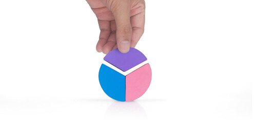 Business connecting piece of multi colored pie wood chart in hand
