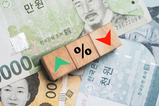 Increasing and decreasing percentage print screen to wooden cube block on Won South Korea  banknote for currency exchange rate concept.