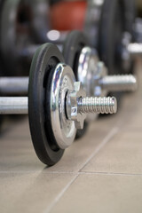 Fototapeta premium Black dumbbells on the gym floor