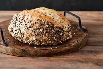 Freshly baked multigrain bread on rustic background.