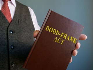 Lawyer shows Dodd-Frank act in the hands.