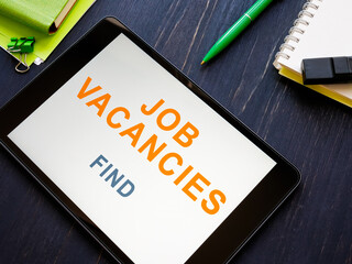 Tablet with words Job vacancies on the screen.