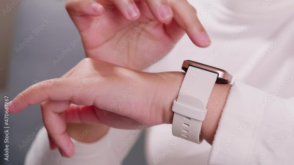 Aufkleber close up shot of a woman hand who touch and scrolling on a smartwatch in order to quickly check appl
