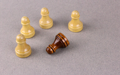 A group of white chess pawns against one black one. The concept of racism. Unequal Combat Concept