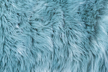 Trendy artificial fur texture. Fur pattern top view. Blue fur background. Texture of blue shaggy fur. Wool texture. Flaffy sheepskin close up