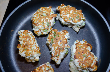 fried chicken mince patties with green on the blue iron pan top view