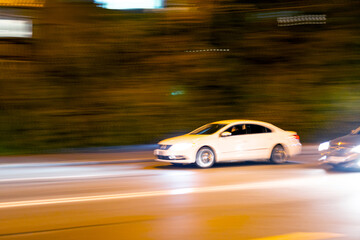 Blurred car traffic on the background of the road in the city at night