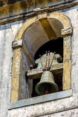 Obraz premium Colonial-style church tower with old bell in the city of Ouro Preto in Minas Gerais