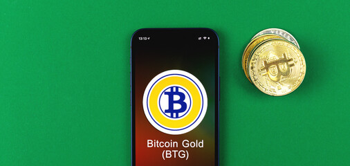 Bitcoin Gold symbol. Trade with cryptocurrency, digital and virtual money, banking with mobile phone concept. Business workspace, banner, table top view photo