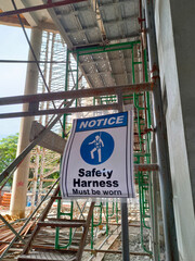 MELAKA, MALAYSIA - 4 MAC 2021: A ‘Safety Harness Must be Worn’ sign was hung as a reminder to...