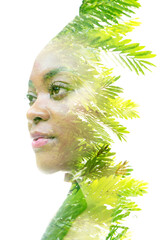 A double exposure portrait of a woman combined with an image of a plant. Dreaming about nature.