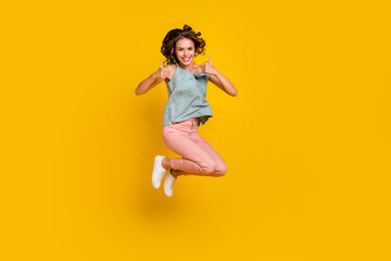 Fototapeta na wymiar Full body photo of cheerful young happy woman jump up show thumb-up cool isolated on yellow color background