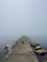 Foggy Jetty Over Lake Looking Towards Hidden Lighthouse