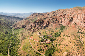 Aerial drone view over an epic gorge in a river valley with red geological rocks. Shot in the area...