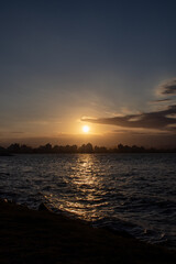 beautiful moment of sunset in the late afternoon, sunbeams on the water and the sky with white clouds