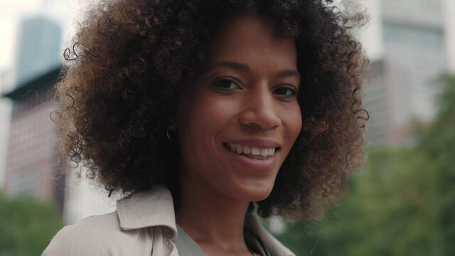 African american woman staning on street and smiling