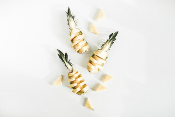 Naklejka premium Sliced pineapple on white background. Flat lay, top view tasty fruit arrangement