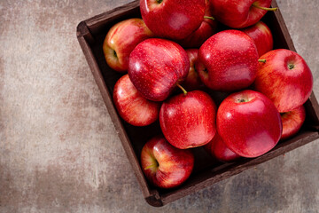Ripe red apples in wooden box. Top view with space for your text.