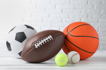 Set of different sport balls on white wooden table