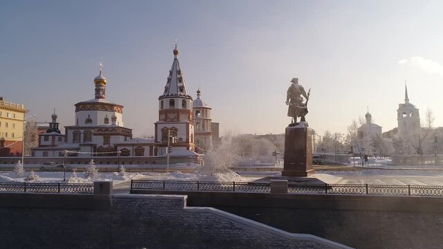Monument to the founders of Irkutsk Yakov Pokhabov on the banks of the Angara River. drone shooting. Winter weather, soaring water.