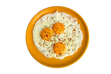 scrambled eggs with spices on an orange plate, top view
