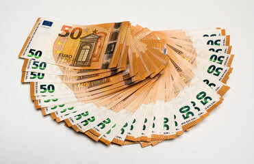 Fifty euro banknotes lie as fan on white background