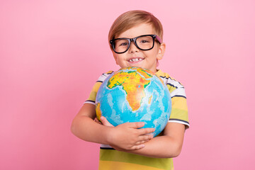 Photo of little happy cheerful boy hands hold globe lesson education lesson isolated on pink color background