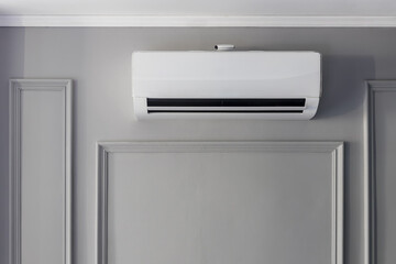 Air conditioner installation on the white wall background. cooling product for hot climate in...