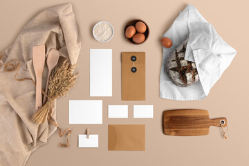A blank branding set, featuring business cards, envelopes, cards, bread, eggs, flour, serving...