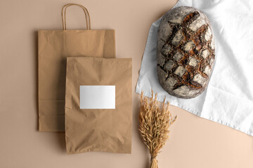 Craft paper blank shopping bags with bread, bakery branding mockup, empty space to display your...