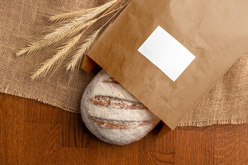 Bread in the blank paper bag with label, bakery branding mockup, empty space to display your logo...