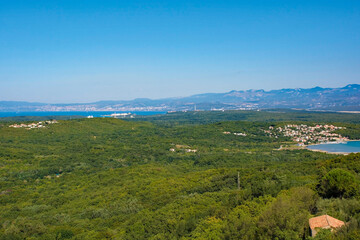 The landscape around the historic medieval hill village of Dobrinj on Krk island in the Primorje-Gorski Kotar County of western Croatia. Rijeka on the Croatian mainland can be seen in the background.