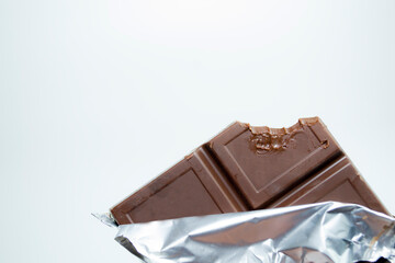 a bitten chocolate bar on a white background.