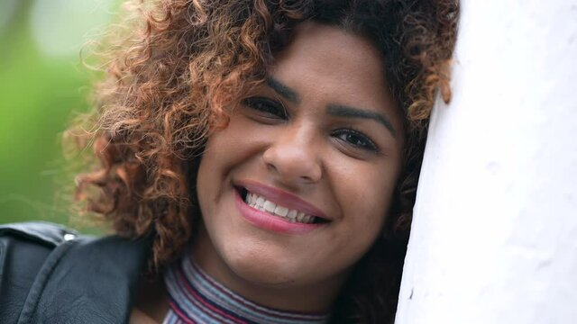 Brazilian woman face close-up smile. Natural hispanic girl smiling