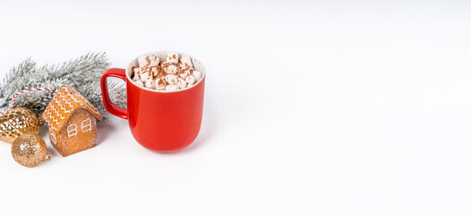Red Christmas cocoa mug with marshmallow on a white background with gingerbread. Copy space banner