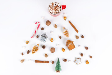 Creative Christmas composition of Christmas accessories, toys laid out in the form of a Christmas tree on a white background. Flat flat, top view