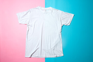 White t-shirt mockup on colorful background. Flat lay tee template