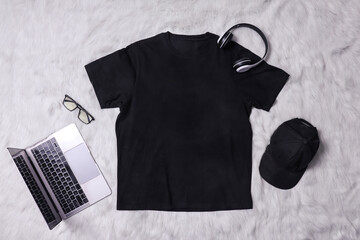 Black t-shirt mockup with man accessories on grey background. Flat lay tee template 