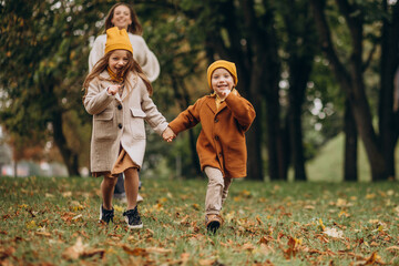 Fototapeta premium Mother with kids having fun in park