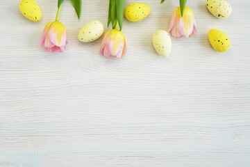 Easter background, pastel colors tulips and yellow eggs decorations, space for text or product, banner.