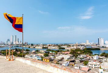 Colombian flag on top of the Castillo San Felipe de Barajas, a fortress in Cartagena, Colombia, South America - obrazy, fototapety, plakaty