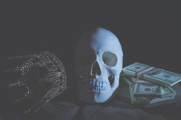 Conceptual image of human skull, crown and money as metaphor that nothing is eternal.
