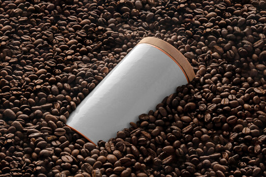 Blank coffee container mockup on coffee seeds background, coffee packaging mockup with empty space to display your branding design.