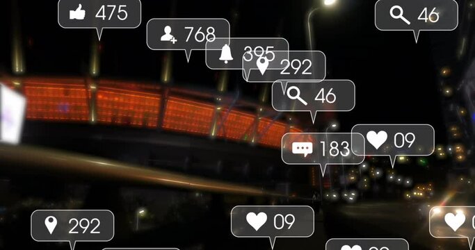 Animation of social media icons and numbers over road traffic and city at night