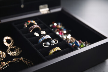 Jewelry box with stylish bijouterie on table, closeup