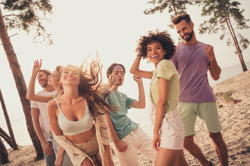 Portrait of attractive cheerful people group spending day dancing chill out having fun at beach...