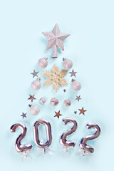 Christmas decoration with silver toys, stars, balls and 2022 numbers in the shape of a New Year tree