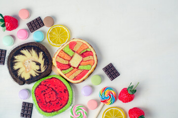 Colorful and various kind of sweets, candies and cake over white background