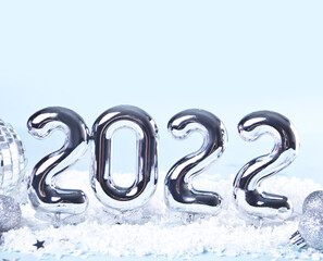 Christmas decoration with silver toys, stars, balls and 2022 numbers